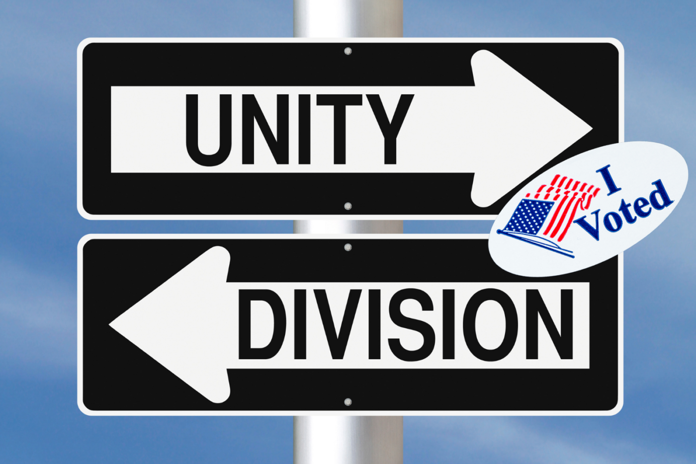 A street sign showing 'Unity' pointing in one direction and 'Division' in the opposite, with a small ‘I Voted’ sticker on the post.