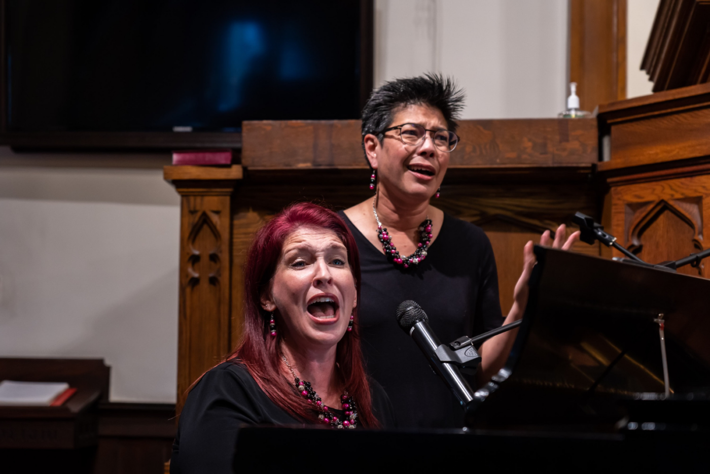 Mo and Katy singing together at the piano, capturing a moment of musical connection and rediscovery.